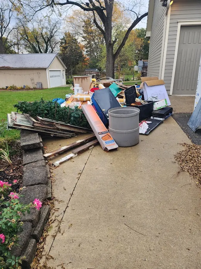 Dumpster being loaded with debris for Estate Cleanout Dumpster Rental in Rochelle Park